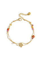 Braccialetto con ciondoli a forma di stella e fiore, perle, pietre e perline.